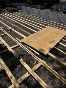 ubber Roof Project Bellingham MA: Framing and preparation stage of the rubber roofing installation, showing skilled workmanship in progress.