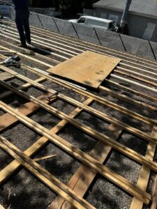 ubber Roof Project Bellingham MA: Framing and preparation stage of the rubber roofing installation, showing skilled workmanship in progress.