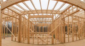 Framing Services MA & RI: Wooden framing structure under construction, showcasing sturdy beams and precise craftsmanship.